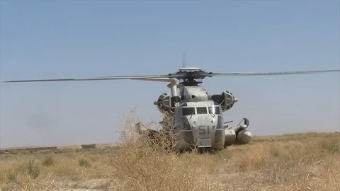Front view of an US army helicopter preparing to take off in an Afghan field Video stock 86295615
