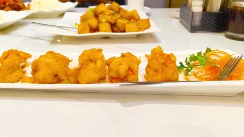 Front view of vibrant delicious fried crispy egg yolk shrimp garnished with.. Video stock 318247723
