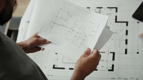 Front view video of man reviewing kitchen furniture designs Stockbeeldmateriaal 134607750