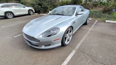 Front view video of a pristine silver Aston Martin DB9 Coupe Stock-Footage 339303237