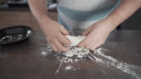 Front view video of an unrecognizable man kneading a pizza dough Video stock 146551777