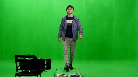 Front view of a walking man in black peaked cap on chroma key background Stock Footage 77716076