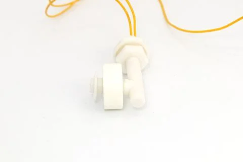Front view of a water level or liquid level sensor with float switch and yell Stock Photos