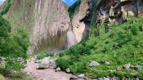 Front view of waterfall in mountains. Strong flow of water with dirt and mud Stock Footage 148710160