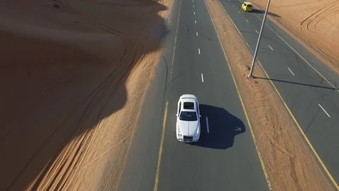 The front view of white Chrysler rides forward along a desert road Stock-Footage 92681760