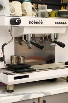Front view of white espresso machine with cups on counter Stock Photos