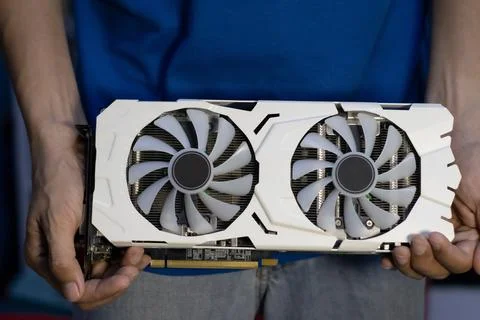 Front view of white graphics card, computer parts, technician holding graph.. Stock-Fotos