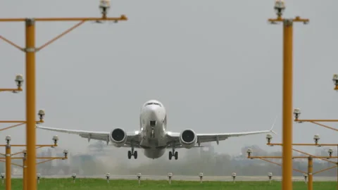 Front view white passenger aircraft taking off from runway Vídeo Stock 333647183