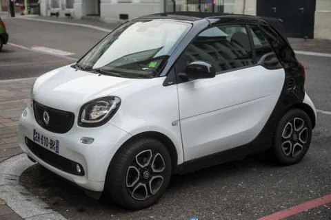 Front view of white Smart car parked in the street Stock Photos