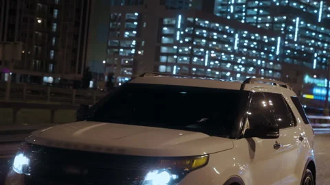 Front view of white tinted SUV car driving in the rain, xenon headlights shining Stock Footage 196290336