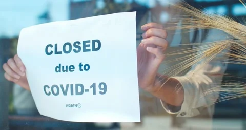Front view of window of closing flower store during pandemic period. Young Stock Footage 138699549