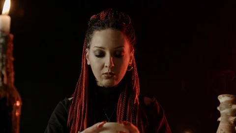 Front view of witch with braids predicting fate by coffee grounds Stock-Footage 125023996