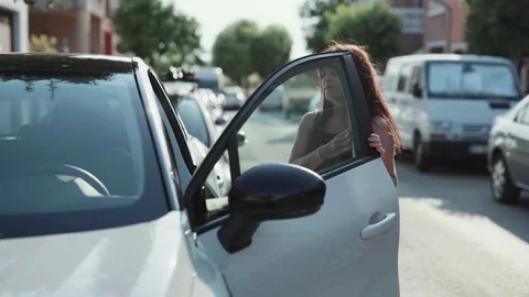 Front view of a woman getting into a car Stock Footage 201467623