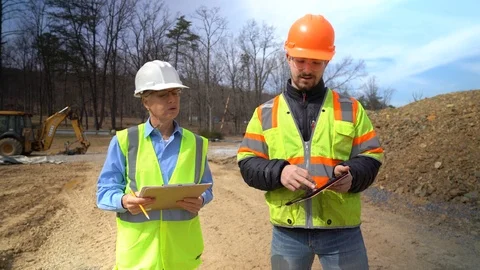 Front view of woman project engineer and job foreman on a construction site. Video stock 127123487
