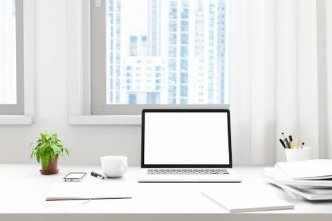 Front view of workpark with blank laptop screen, blank frame, and notebook in Stock Photos
