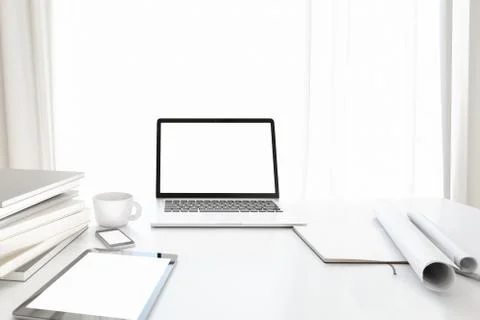 Front view of workpark with blank white computer screen, coffee cup, and book in Stock Photos
