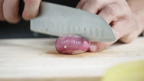 Front view of yong man cook cut thin slices of red onion with knife on cutting 스톡 동영상 74346025