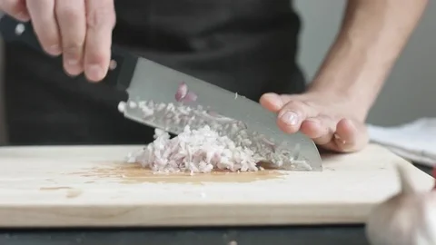 Front view of yong man cook cut thin slices of red onion with knife on cutting 스톡 동영상 74346103