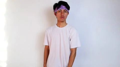 Front view of a young Asian man in a white shirt doing sports lifting a bar.. Stock Footage 276394687