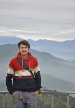 Front view of a young guy looking at camera, posing with hands in pocket  Stock Photos
