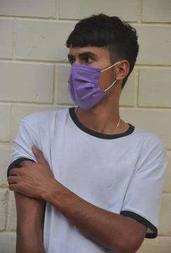 Front view of a young guy wearing face mask with looking sideways  Stock Photos
