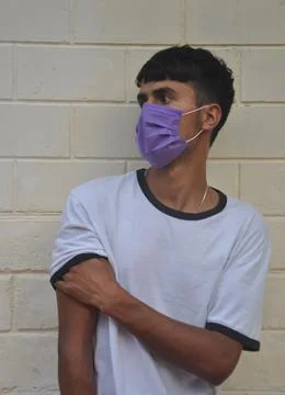 Front view of a young guy wearing face mask with looking sideways  Stock Photos