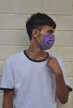 Front view of a young guy wearing face mask with looking sideways  Stock Photos