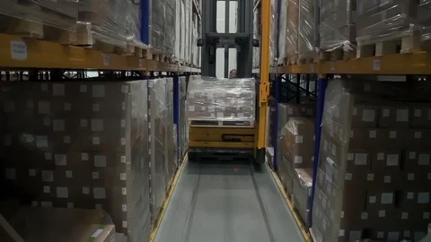 Front view of young male worker using loading equipment in industrial warehouse. Stock Footage 127674808