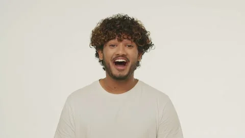 Front view of young man hearing good news. Studio footage of excited guy with Stock Footage 232803934