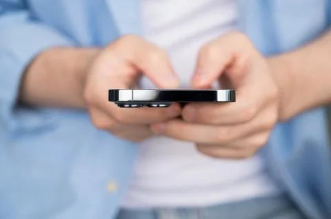 Front view on young man holding smartphone.Selective focuse.Modern technologies Stock Photos