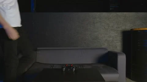 Front view of a young man playing video games on couch at home Vídeo Stock 136329768