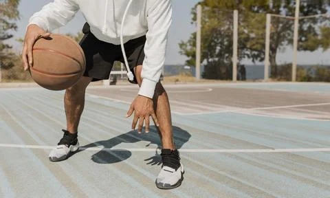 Front view young man playing basketball outside 2 Resolution and high quality Stock Photos