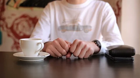 Front view of a young man's hands, coffee Cup and wallet Stock Footage 113671626
