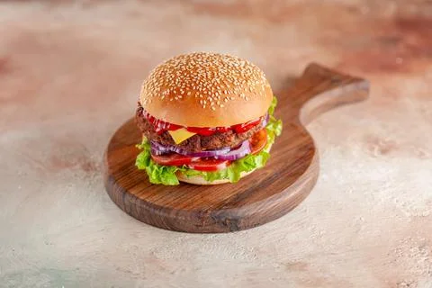 Front view yummy meat cheeseburger on cutting board light background salad .. Stock Photos