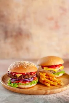 Front view yummy meat cheeseburger with french fries on cutting board light.. Stock Photos