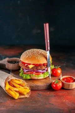 Front view yummy meat cheeseburger with french fries on dark background sal.. Stock Photos