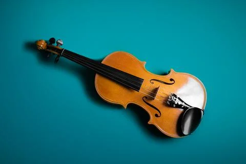 The front of a violin. Isolated by a blue background. Stock Photos
