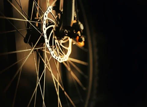 The front wheel of a bicycle on a dark background. Bicycle details. Sports an Foto stock