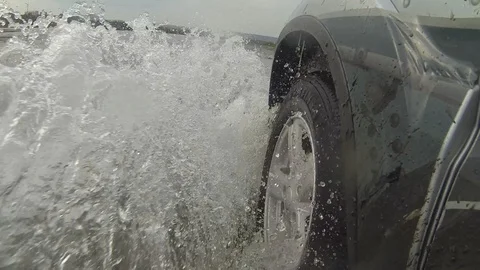 The front wheel of the car. water spray at high speed. The spray from the wheels Stock Footage 96372289