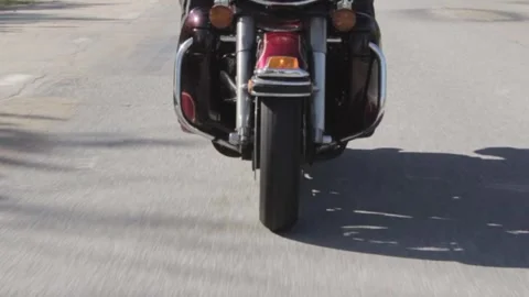 Front wheel of a motorcycle from the front while driving on the road Stock Footage 247901095
