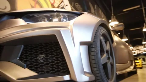 Front wheel of a silver car in the Illskill Stock Footage 299650725