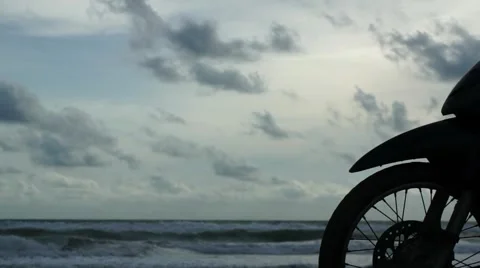 Front wheels of motorcycle parked at the beach Stock Footage 63443136
