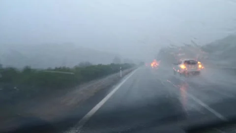 Front window of a car with working wipers and streams of water Stock Footage 253131758