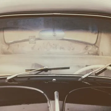 Front window of a dirty old black car Stock Photos