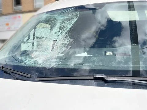 Front window of a van broken by a rock Stock Photos
