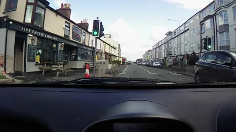 Front windscreen footage driving through built up town Stock Footage 247561277