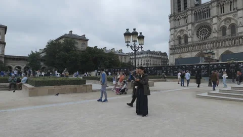 The front yard of the Notre Dame Cathedral with many tourists walking around. Stock Footage 278919574