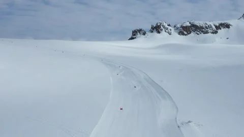 Frontal aerial static view of alpine downhill slalom skier carving Stock Footage 250597639