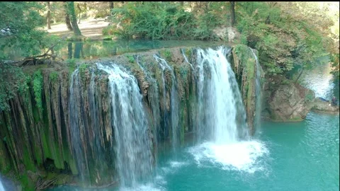 Frontal aerial view of the waterfalls produced by the river elsa in the hills Video stock 161760053