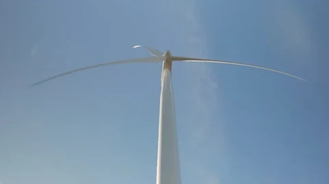 Frontal below view of Wind Turbine spinning UHD 4k Stock Footage